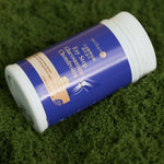 Glucosamine_Chondroitin_supplement_bottle_lying_on_green_textured_surface