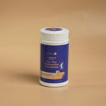 Glucosamine_Chondroitin_supplement_bottle_lying_on_green_textured_surface_front_view