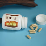Lingzhi_Plus_bottle_tilted_with_capsules_spilling_out_on_blue_background