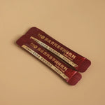 Pair of red sachets labeled Pu’er tea mix with tangerine peel