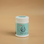 Qingshi Tablet bottle with teal label on beige background