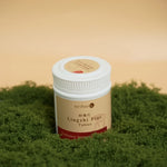 White_plastic_bottle_of_Oriherb_Lingzhi_Plus_tablets_on_green_moss_background