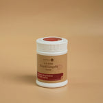 white plastic bottle with brown label of Royal Lingzhi capsule angled on beige background